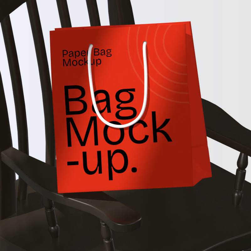Red Shopping Bag On Black Wooden Rocking Chair Under Beautiful Lighting 3D Mockup